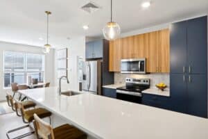 a kitchen with a white countertop and blue cabinets