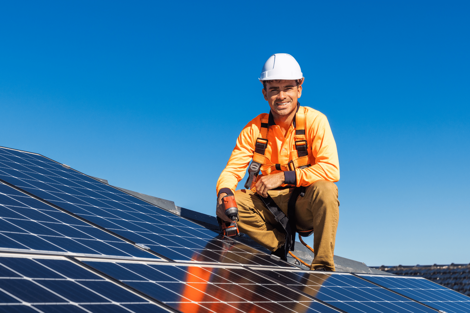 a man wearing a hard hat and holding a drill on a solar panel | Acquisitions | Princeton Properties